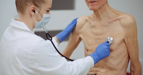 female doctor examine elderly man with stethoscope 1