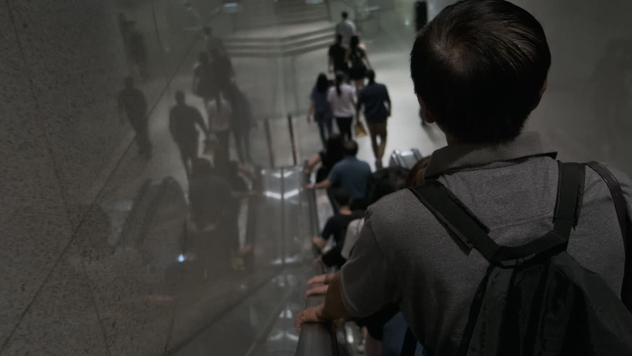 Commuters on Escalator in Underground Station