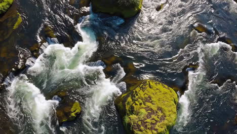 aerial view of river rapids with mossy rocks