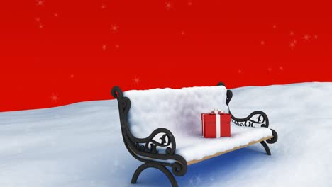 Animation-Von-Schnee,-Der-über-Ein-Rotes-Weihnachtsgeschenk-Auf-Eine-Schneebedeckte-Bank-Fällt