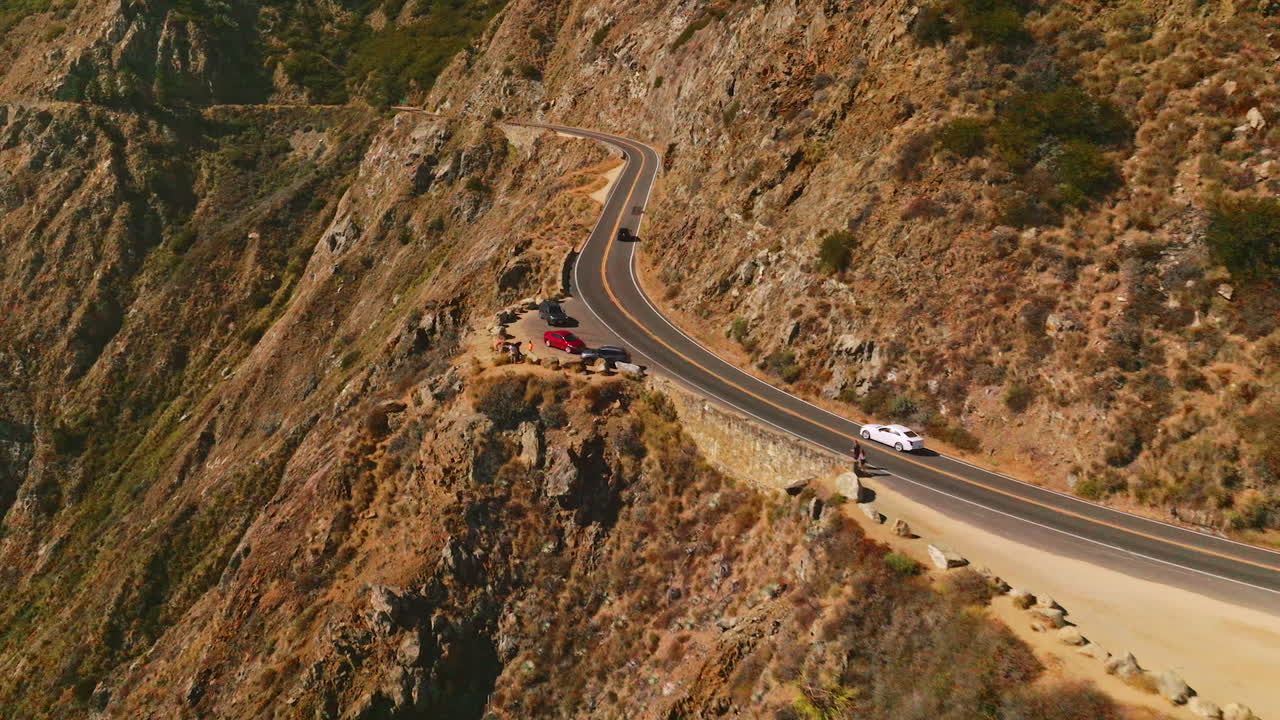Flying along the road passing through the mountains. Huge rocks of Big Sur Morro Bay in California, USA.