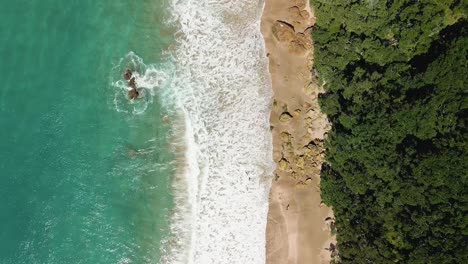 Cinematic-reveal-of-Hot-Spring-in-New-Zealand-at-high-tide-along-coast-line