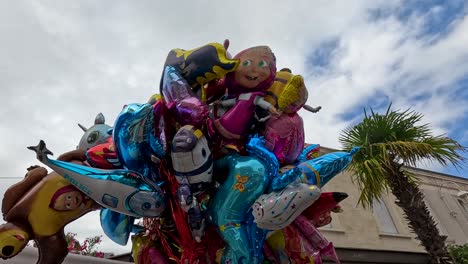 vibrant balloons float against a blue sky