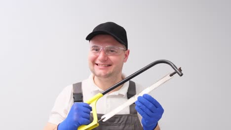 a construction worker holds a saw
