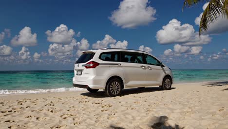 white van on a tropical beach