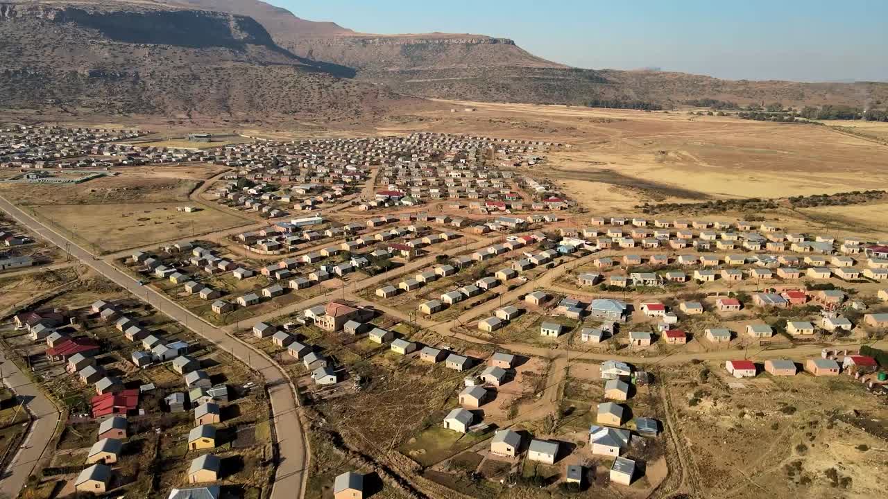 Aerial View of a Township Settlement with Mountains in the Background