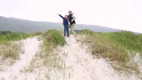 siblings playing on the sand dunes