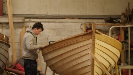 handcrafting a boat: rubbing strake installation.