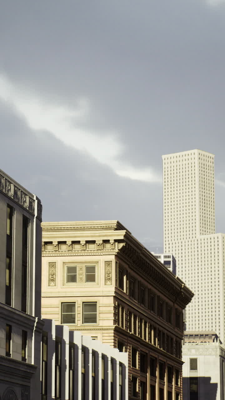 Modern skyscrapers rise above historic buildings in urban landscape