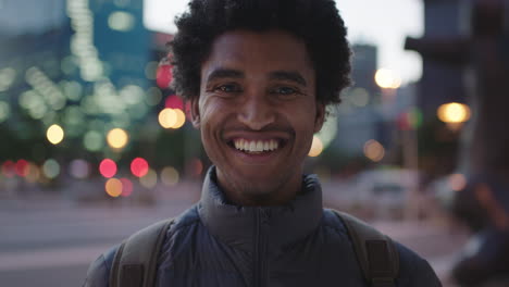 close up portrait of attractive young mixed race man smiling cheerful at camera enjoying calm urban evening in city commuting travel