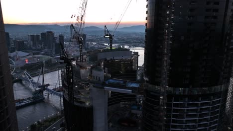 aerial pull away and pan up shot of the top of brisbane city's queens wharf casino development