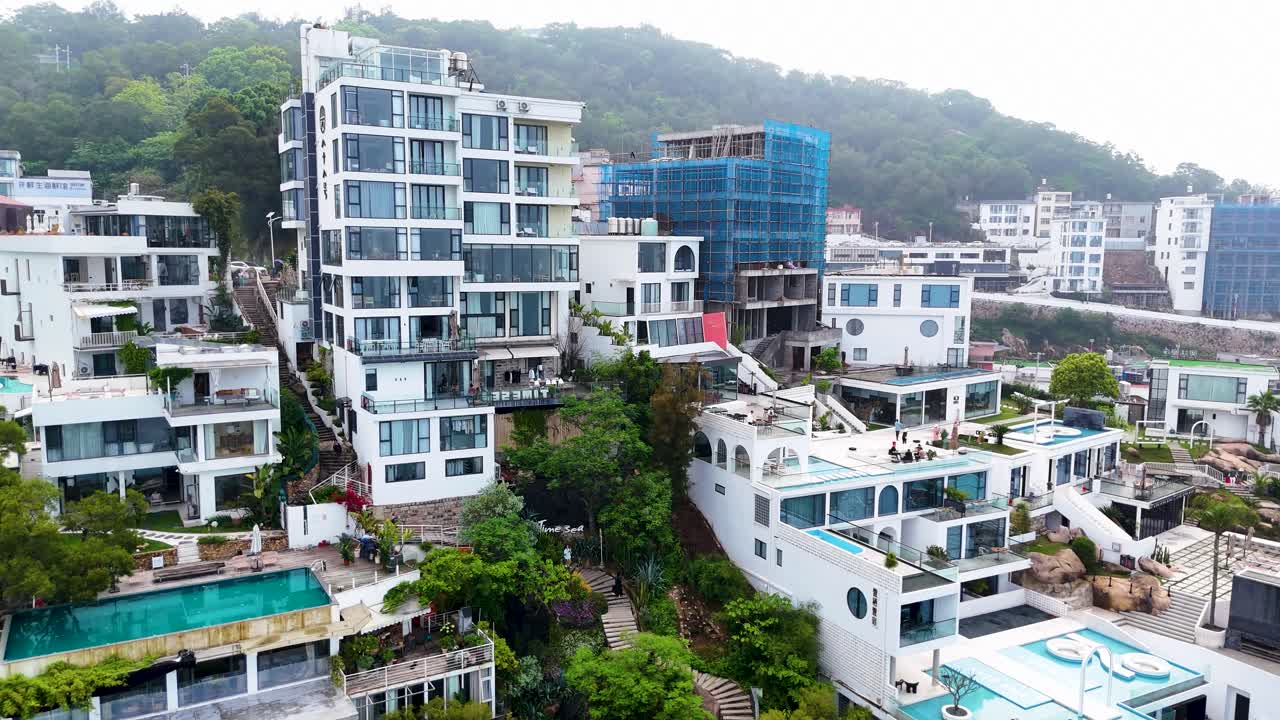 Aerial establishing shot of luxury villas looking onto the sea in Xiapu town, China
