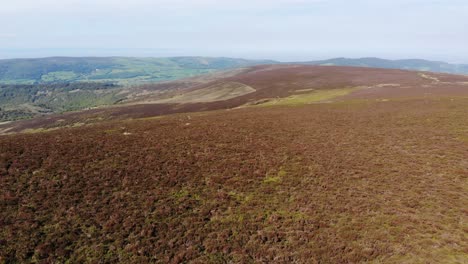 Aerial-descending-view-of-Exmoor-in-Devon-from-Dunkery-Beacon-looking-over-the-Bristol-Channel-towards-Wales