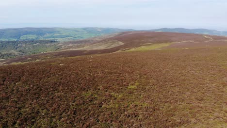 aerial descending view of exmoor in devon from dunkery beacon looking over the bristol channel towards wales