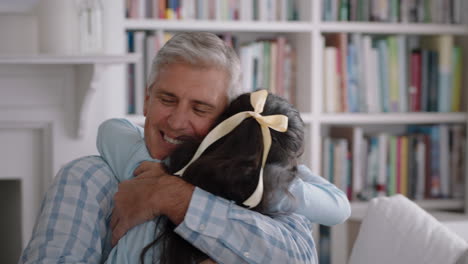 grandfather hugging granddaughter happy little girl embracing grandad enjoying affectionate hug from child sharing love gently holding grandparent at home