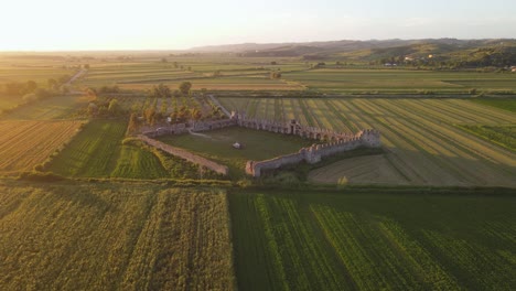 Fortress-of-bashtove-covered-with-the-Greenfields-standing-proudly-front-of-the-sun,-making-an-incredible-view,-Albania