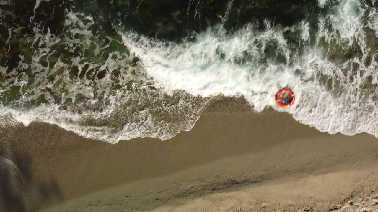 Top view of lifebuoy in the sea shore. Life ring floating in a sea.