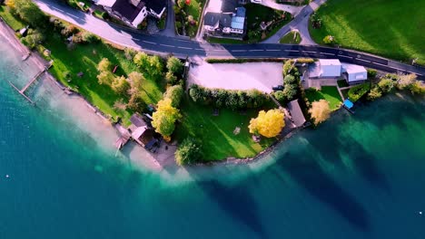 aerial view of a small, quaint town nestled on the shore of a calm, blue lake