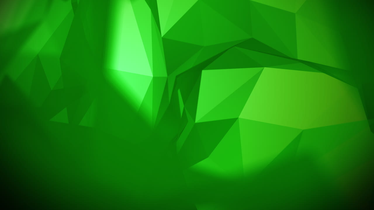 Abstract low poly background of triangles in green colors. Looped animation with a blurred background. Copy space.