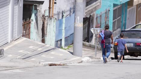 mother and child walking hand in hand on an urban street