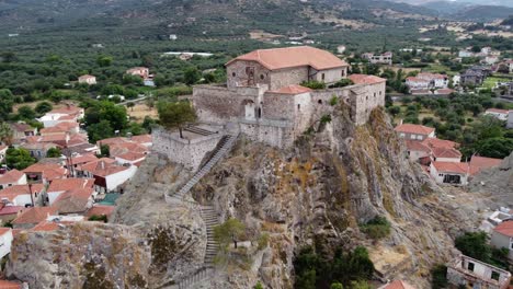 virgin mary greek orthodox church terrace at top of rock surrounding old petra village and aegean sea, lesbos, aerial closeup