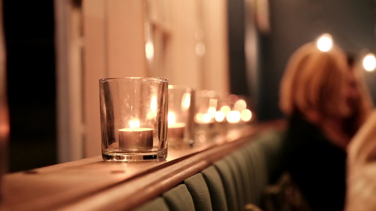 Tea light candles burn on at a party