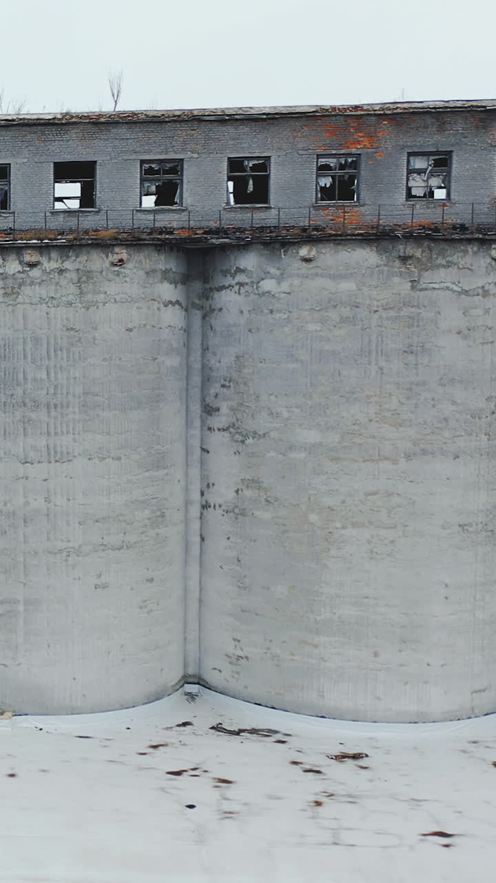Abandoned old building ruins with broken windows. Old industrial edifice for demolition. Aerial view