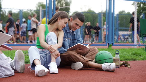 students sitting on running track