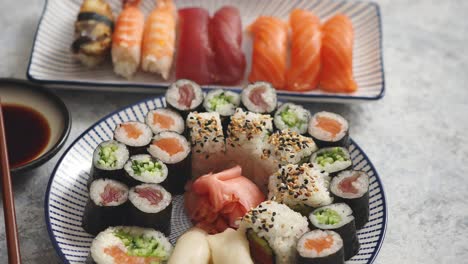 Asian-food-assortment--Various-sushi-rolls-placed-on-ceramic-plates