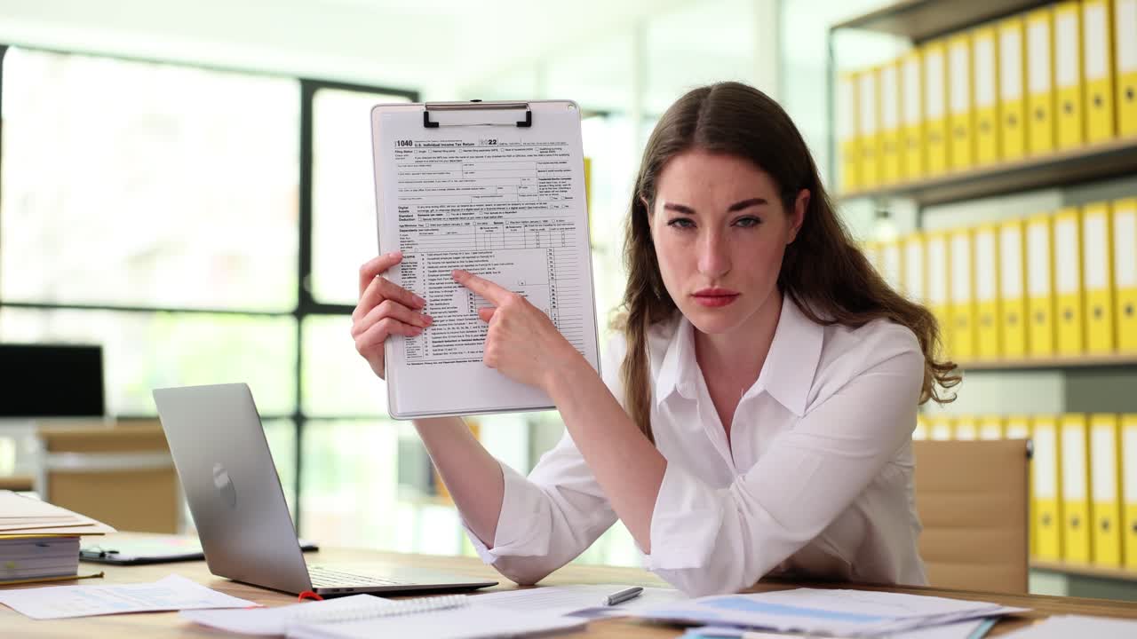 Woman pointing at a tax form in an office
