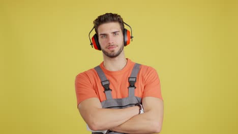 portrait of a confident worker in safety earmuffs and overalls