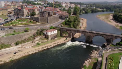 aerial view of barcelos medieval bridge over the cávado river and historic center