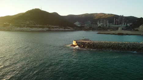 Costa-garraf's-cement-factory-with-rocky-coastline-and-hills-in-barcelona,-spain,-aerial-view