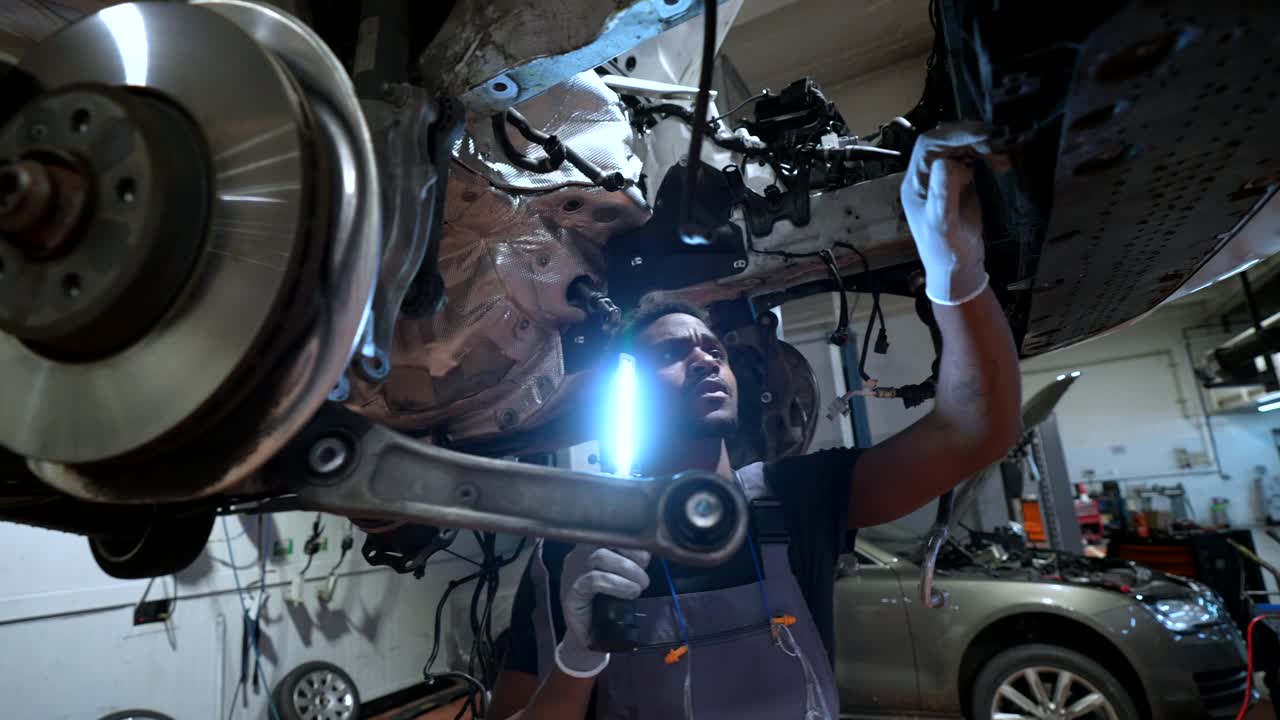 Mechanic Repairing Car in Auto Shop