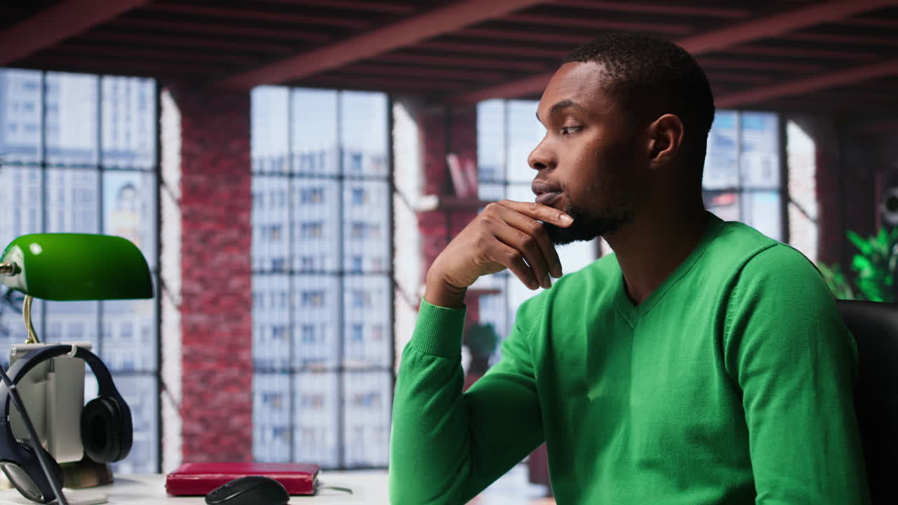 Vertical Video African american guy thinking about new ideas to increase clients numbers