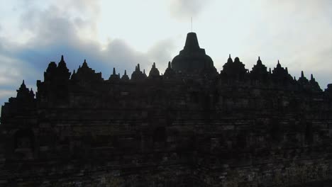 close up aerial walls and stupa of borobudur temple revealing tropical landscape