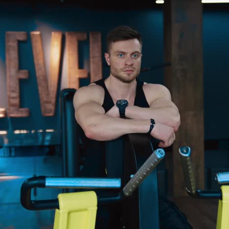 workout in the hardcore gym. muscular athlete training in the modern gym