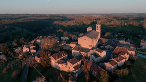 wide aerial view of the village of saint-avit-ségnieur and its church, located in the dordogne region, a magnificent tourist attraction at sunrise