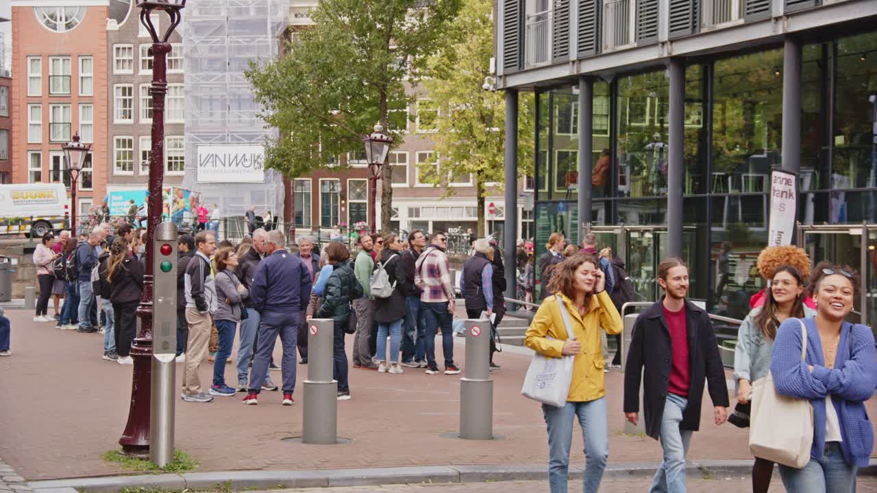 Crowd of Tourists Waiting in Line on a Street in Amsterdam