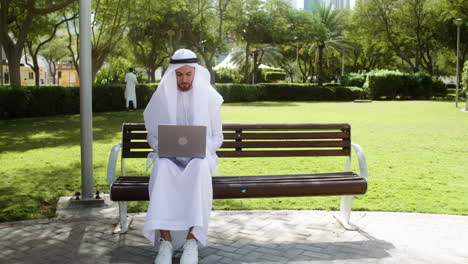 man sitting on the bench of a park