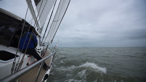 Sailing-yachts-in-France-with-a-sailor-sitting-on-deck