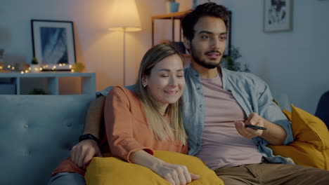 couple watching tv at home