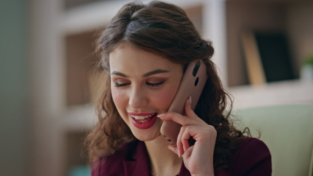 Sales worker calling mobile phone in office closeup. Smiling woman chat client