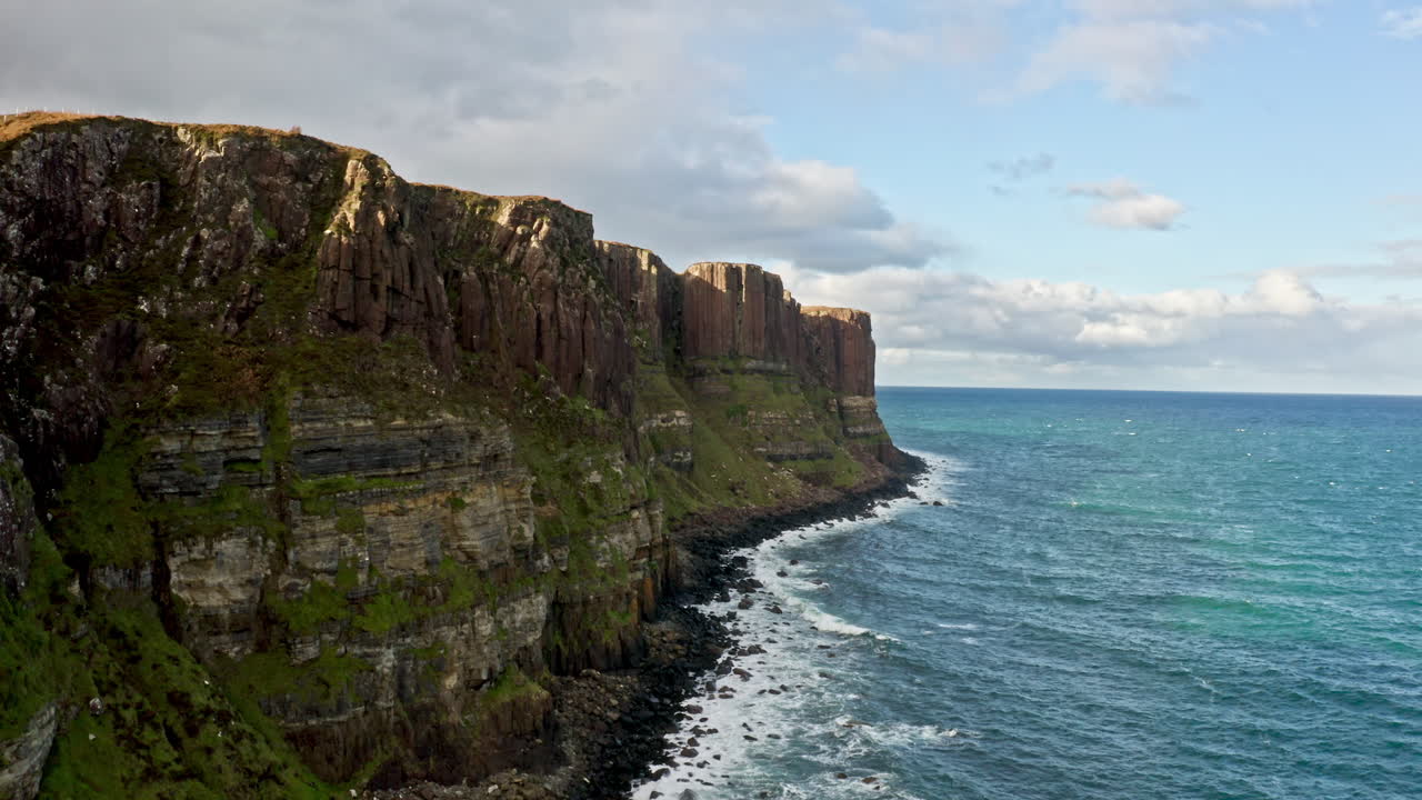 Basalt Cliffs Of Kilt Rock Above Atlantic Ocean On Isle Of Skye In Scotland, UK. drone shot