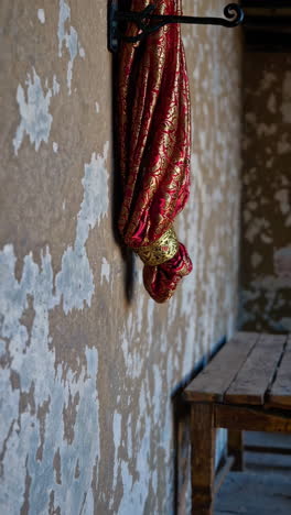 ornate red fabric hanging on a wall