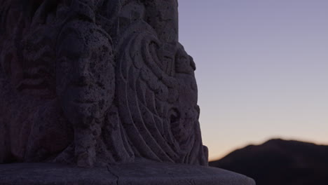 view at night time of a maori stone carving a statue in wellington, new zealand