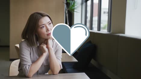 animation of heart icon over businesswoman in office