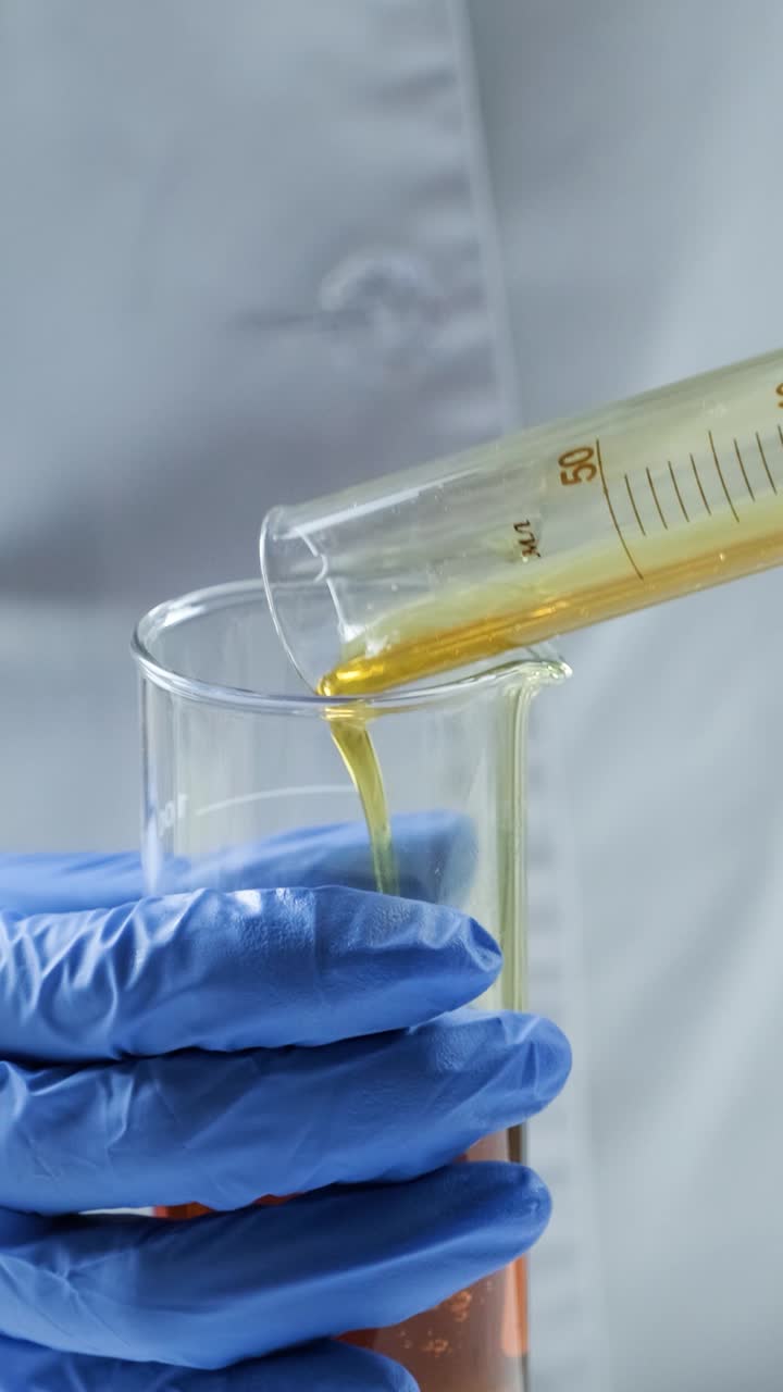 Pouring yellow liquid in beaker