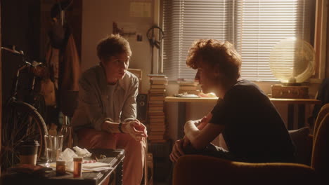 young couple having tense and emotional argument in sunlit room