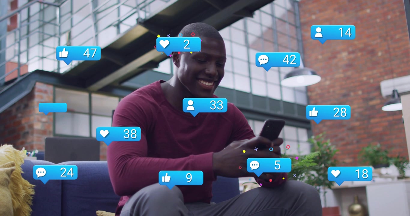 Man checking phone in loft, sparking social bubbles growing around him tapping, smiling for likes